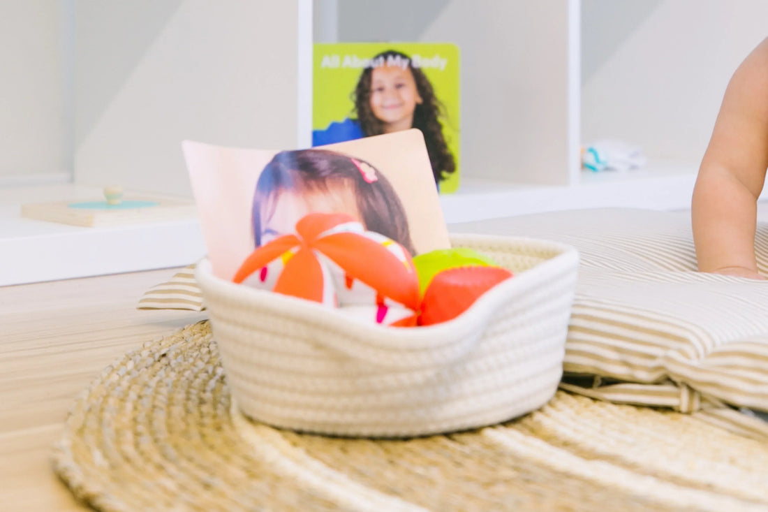 Toddler playing with a Montessori language basket, enhancing language and cognitive development through tactile play.