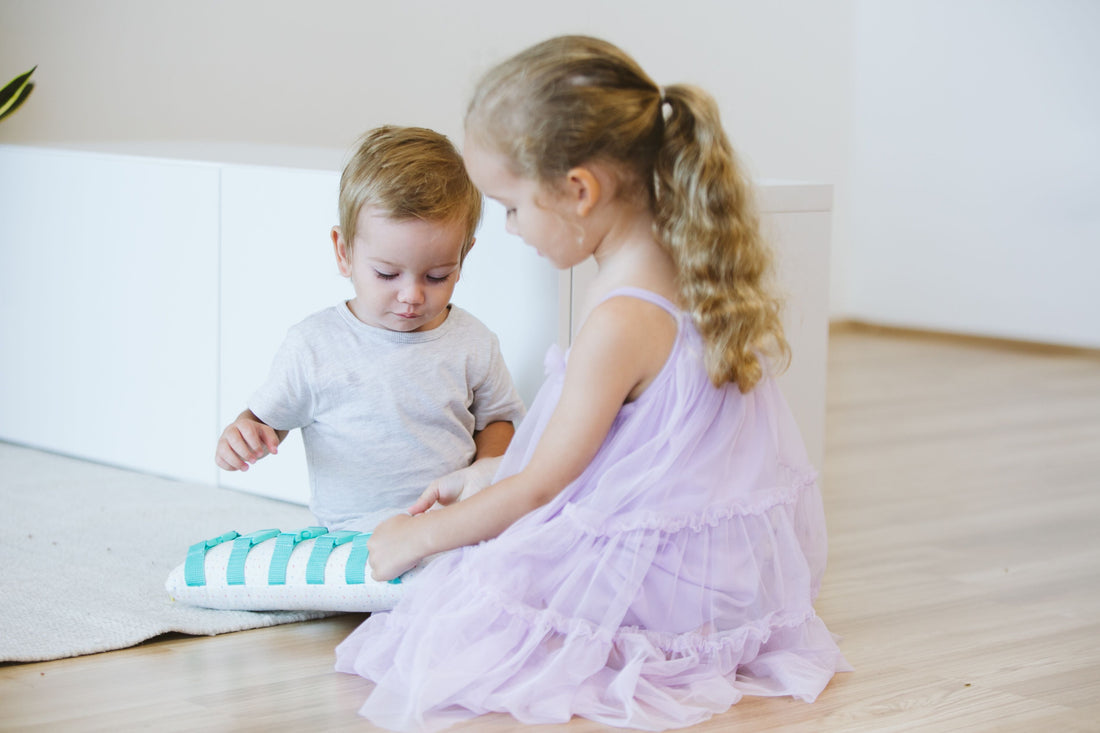 Two toddlers playing together, sharing toys and interacting in a playful and cooperative manner.