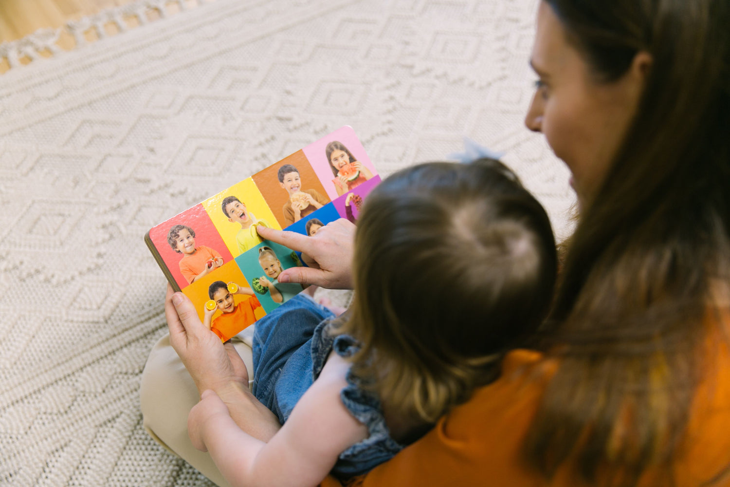 mom and toddler reading book together to encourage reading and pre-writing