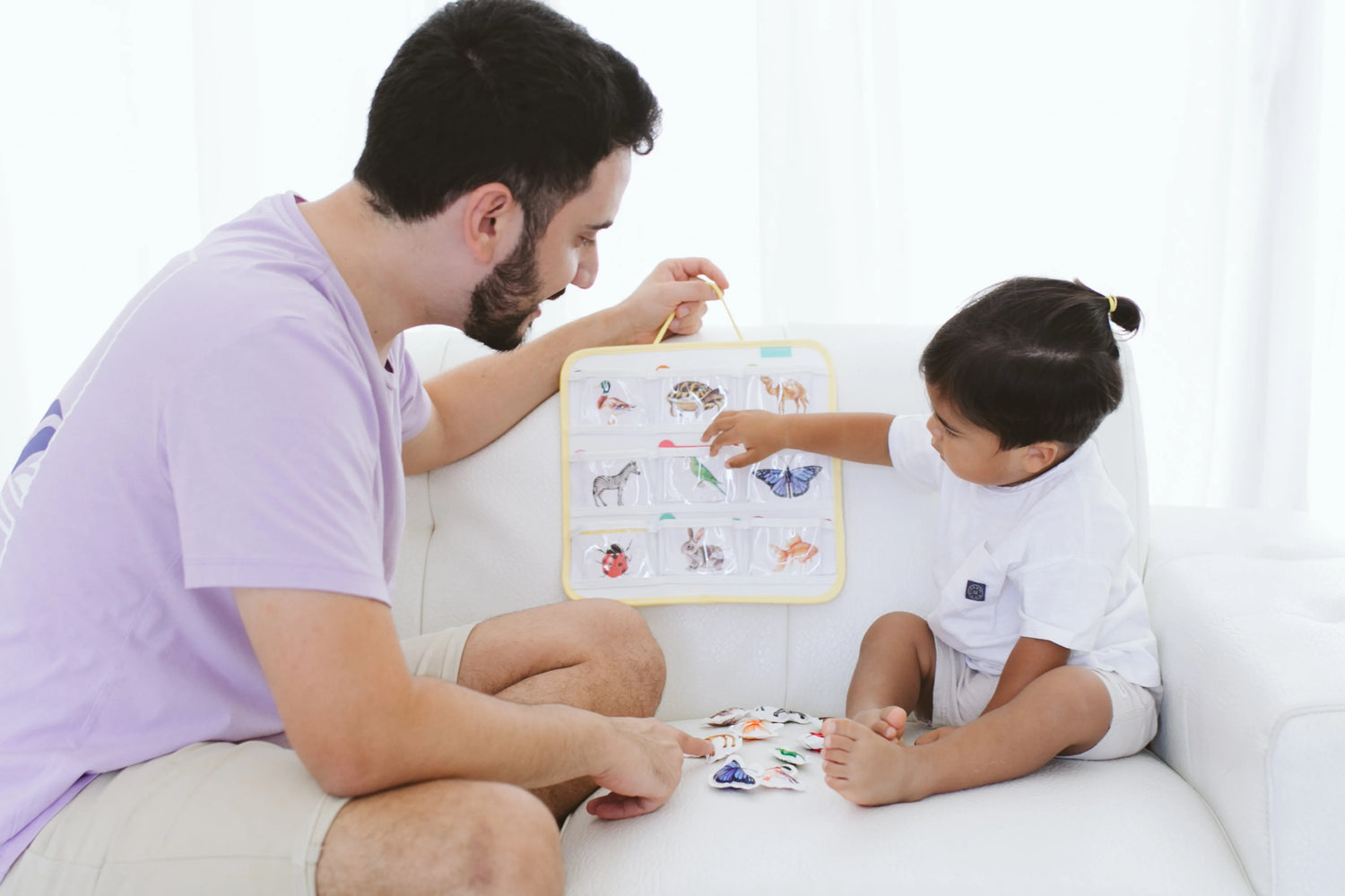 Mother reading a book with her toddler, showing engagement and interaction as part of their language development and bonding time.