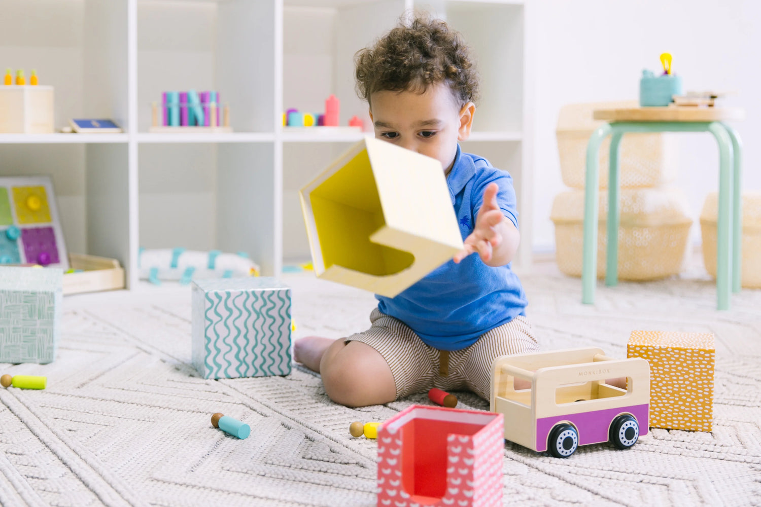 Toddler involved in destructive play, such as knocking over building blocks or throwing toys