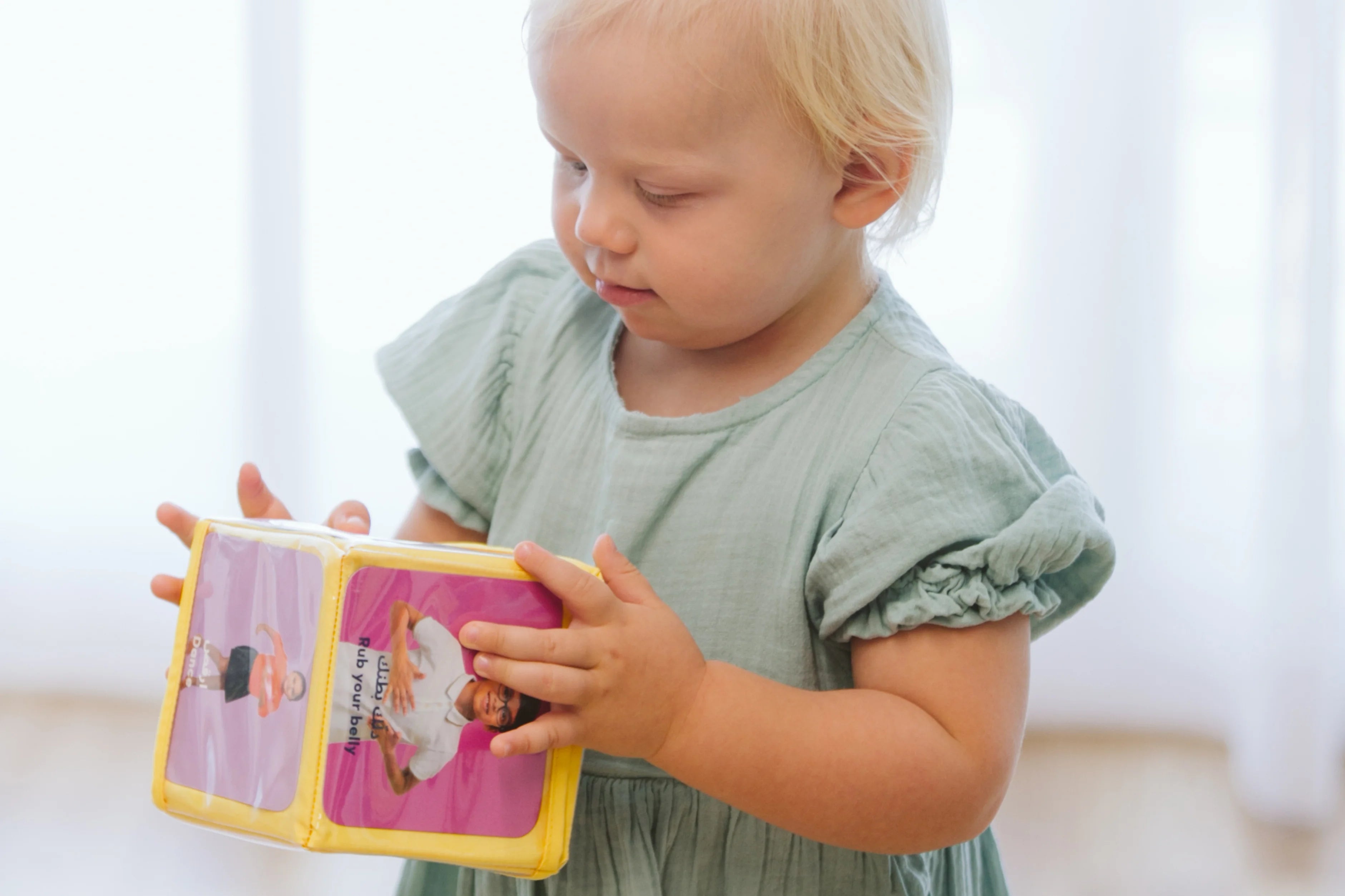 Mother and toddler reading a book about body parts together