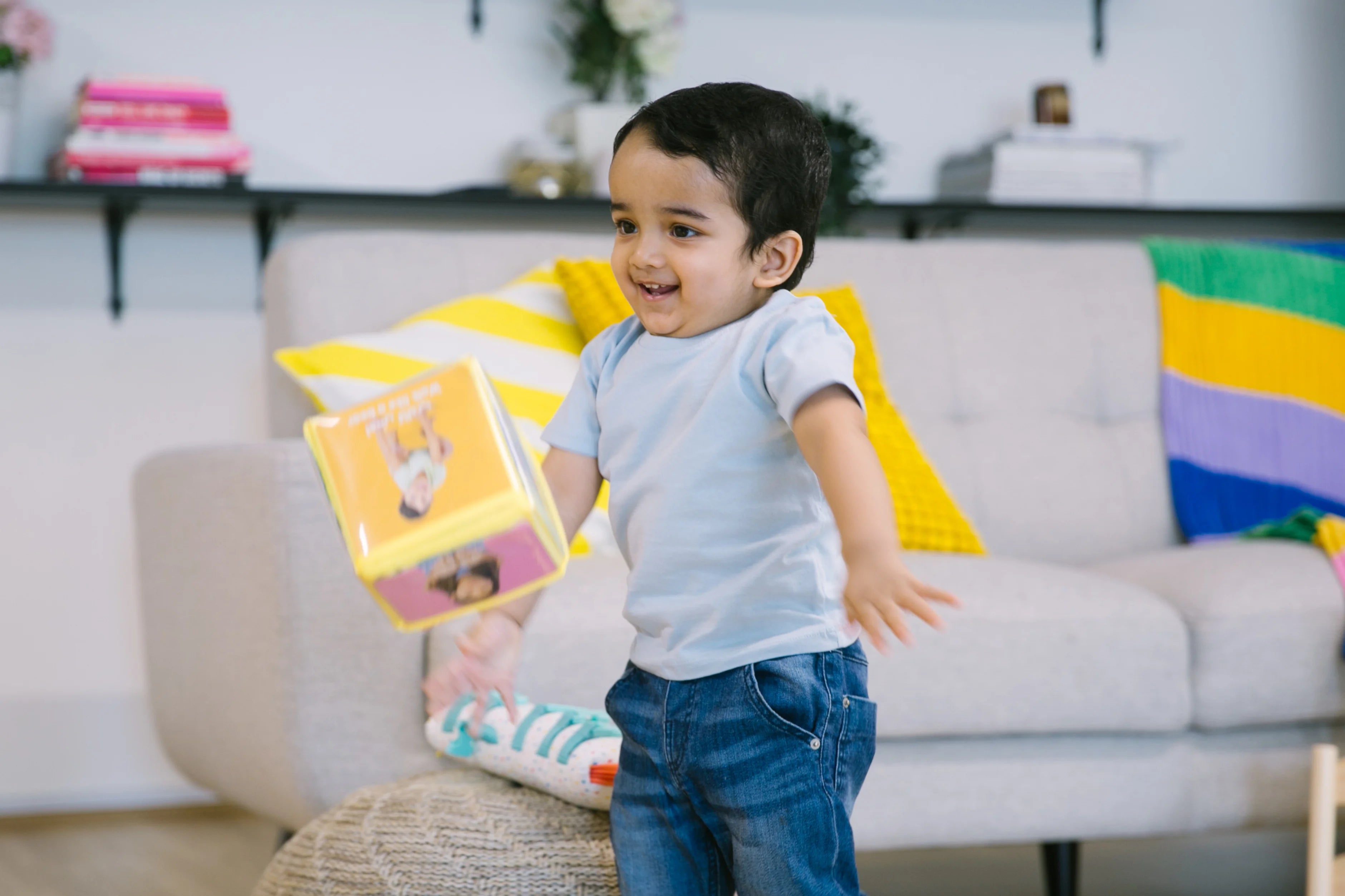 Child examining a toy in their hand, focusing on fine motor skills and safe play